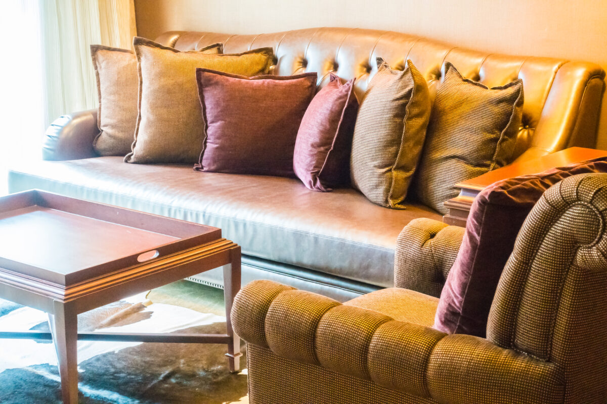 Beautiful luxury pillow on leather sofa decoration in living room interior